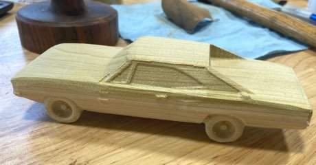Rough model of a car, in wood.