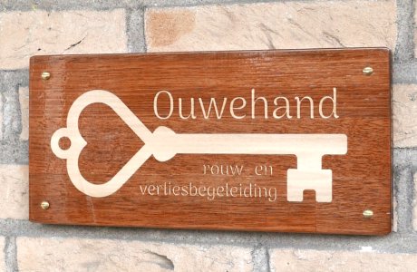 A wood inlay company sign,on the wall